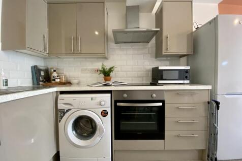 A modern and tidy kitchenette equipped with ess...