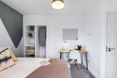 A stylish and well-lit double bedroom featuring...