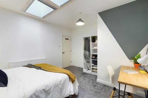 A stylish and spacious double bedroom featuring...