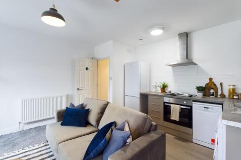 A bright and modern kitchenette with stylish de...