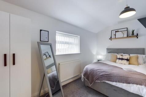 A bright and inviting double bedroom featuring ...