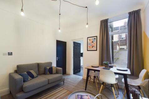 A stylish and spacious living room featuring mo...