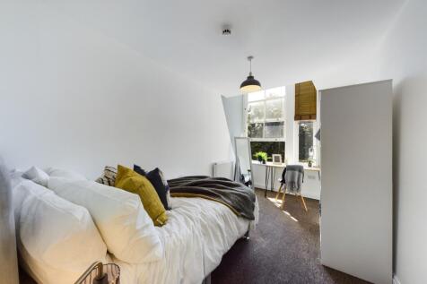 A bright and inviting double bedroom with moder...