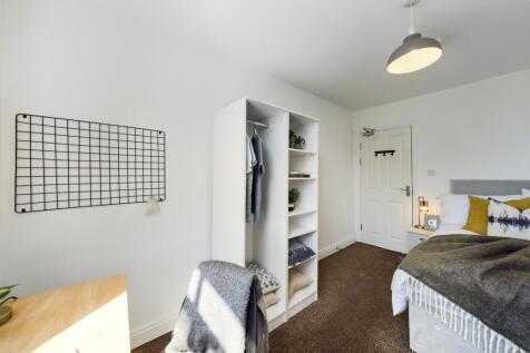 A bright and inviting double bedroom featuring ...