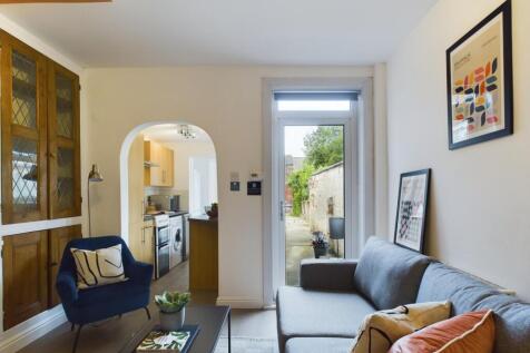 A spacious and inviting modern living room, fil...