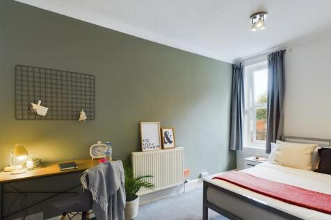 A bright and inviting double bedroom with a mod...