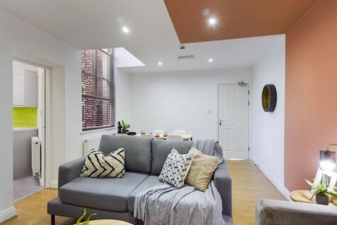 A spacious and stylish modern living room fille...