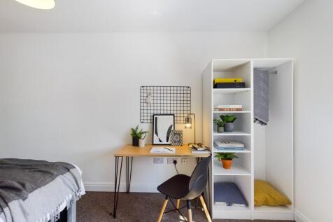 A bright and tidy double bedroom featuring a co...