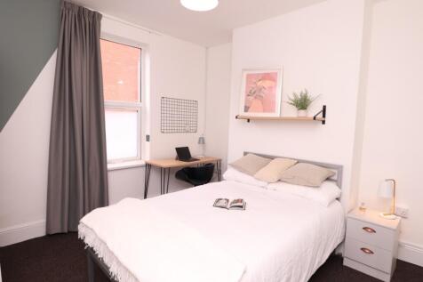 A bright and stylish double bedroom, featuring ...