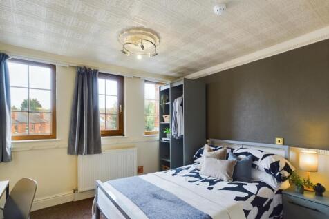 A bright and inviting double bedroom with ample...