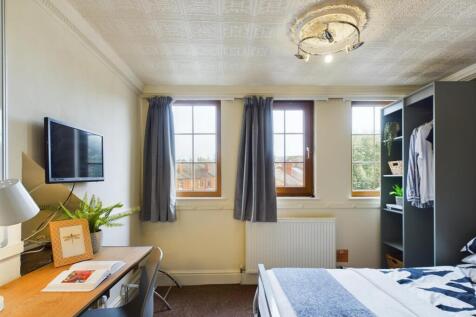 A bright and inviting double bedroom featuring ...