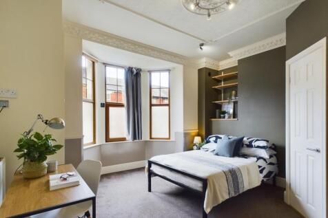 A bright and inviting double bedroom featuring ...