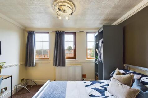 A bright and inviting double bedroom featuring ...