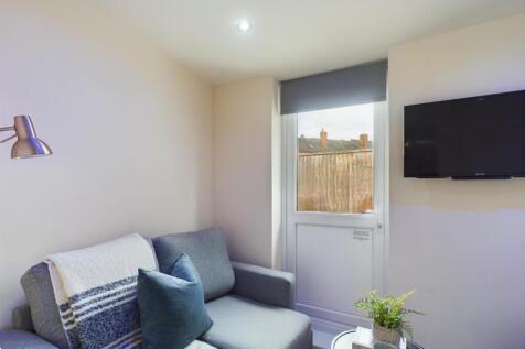 A bright and inviting living room with modern d...