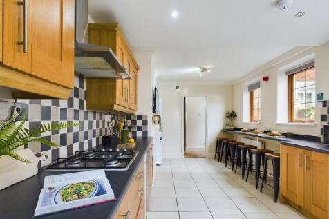 A spacious and modern kitchen with ample natura...