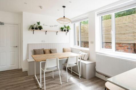 Bright, modern eat-in kitchen with a rustic woo...