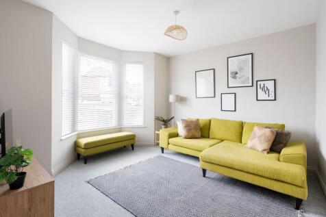 Bright contemporary living room with a large ba...