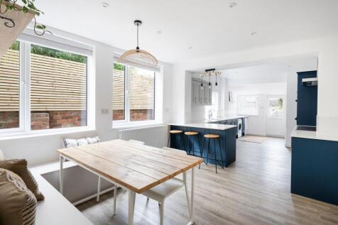 Bright, modern open-plan kitchen and dining are...