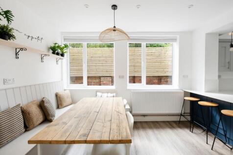 Bright, modern eat-in kitchen with a rustic woo...