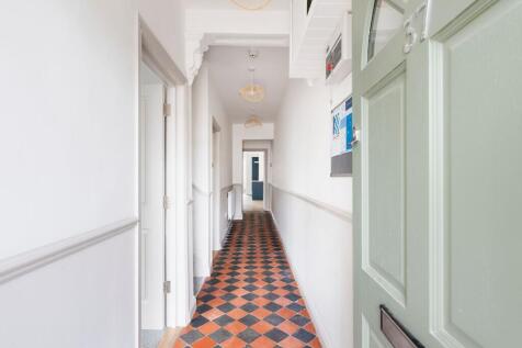Bright, freshly painted hallway with decorative...