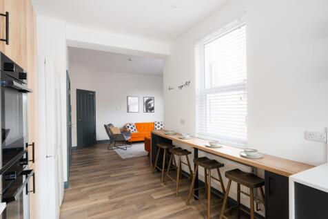 Bright open-plan living and kitchen area with a...