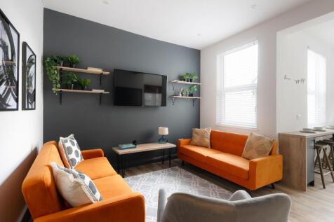 Bright modern living room with matching orange ...