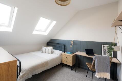 Bright, neatly styled attic bedroom with a sing...