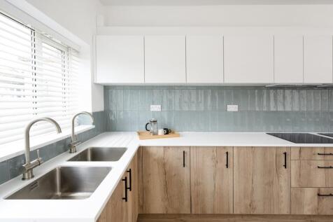 A modern and clean kitchen with ample natural l...