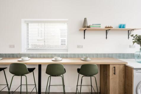A modern kitchen with a clean design, featuring...