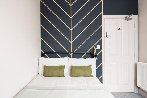 Bright, stylish bedroom with a modern patterned...