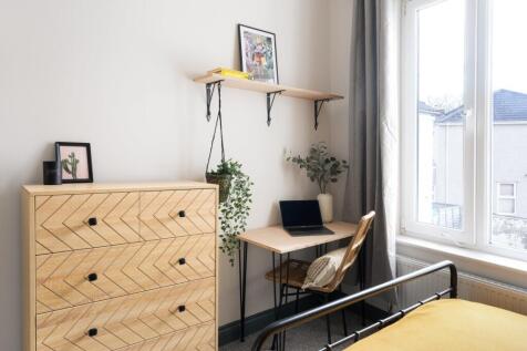 A modern and clean kitchen with wooden cabinets...