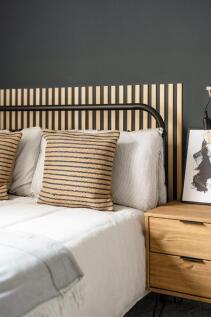 Stylish double bedroom with a modern black meta...