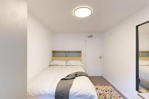 A bright and tidy double bedroom featuring a co...