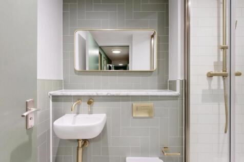 A clean and modern bathroom featuring a large s...