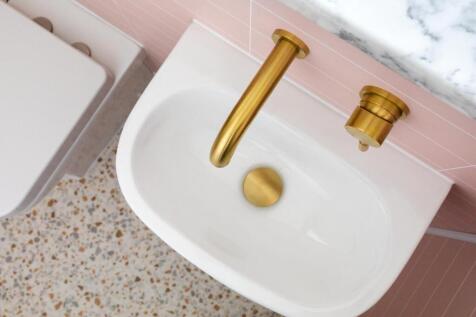 Stylish bathroom washbasin with a modern white ...