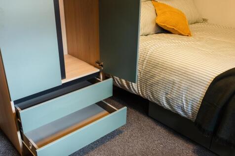 Cozy double bedroom corner with built-in under-...