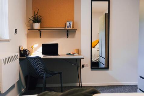 Neat, modern single bedroom workspace with a co...