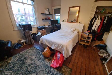 A cozy double bedroom featuring a large window ...
