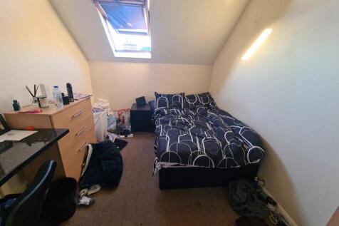 Cozy single bedroom featuring a comfortable bed...