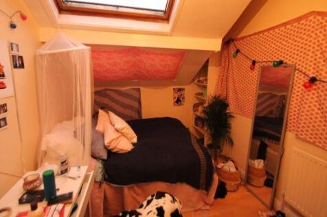 A cozy attic bedroom featuring a skylight windo...