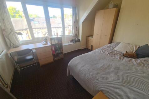 A cozy and bright double bedroom featuring a co...