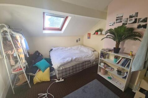 Cozy single bedroom with a skylight window prov...