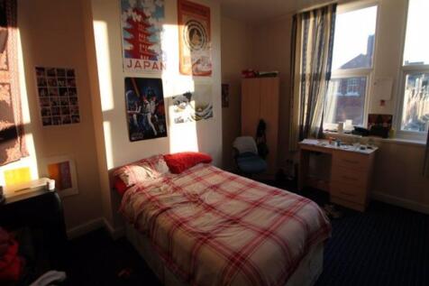 A cozy single bedroom featuring a comfortable b...