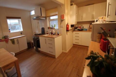 A spacious, well-lit living room with modern fu...