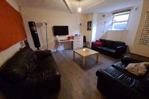 A spacious and welcoming living room featuring ...