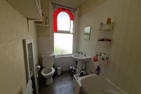 A well-maintained bathroom featuring a bathtub,...