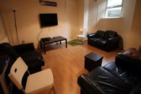 A spacious and modern living room featuring com...