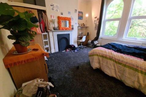 A cozy bedroom with natural light streaming thr...