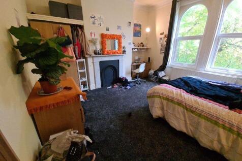 A cozy bedroom with a large window providing na...