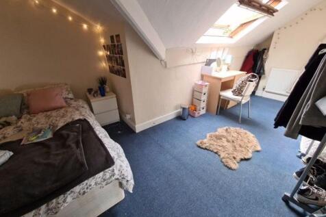 A cozy bedroom featuring a double bed, with a w...